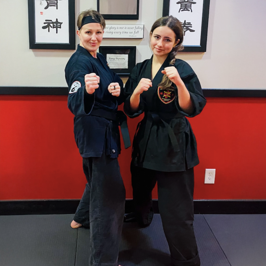 Two adult women training together in martial arts partner drills. Programs include women’s self-defense near me, karate near me, kung fu classes, jiu jitsu near me, and kickboxing classes. Adult martial arts classes develop confidence, strength, and real-world self-defense skills.
